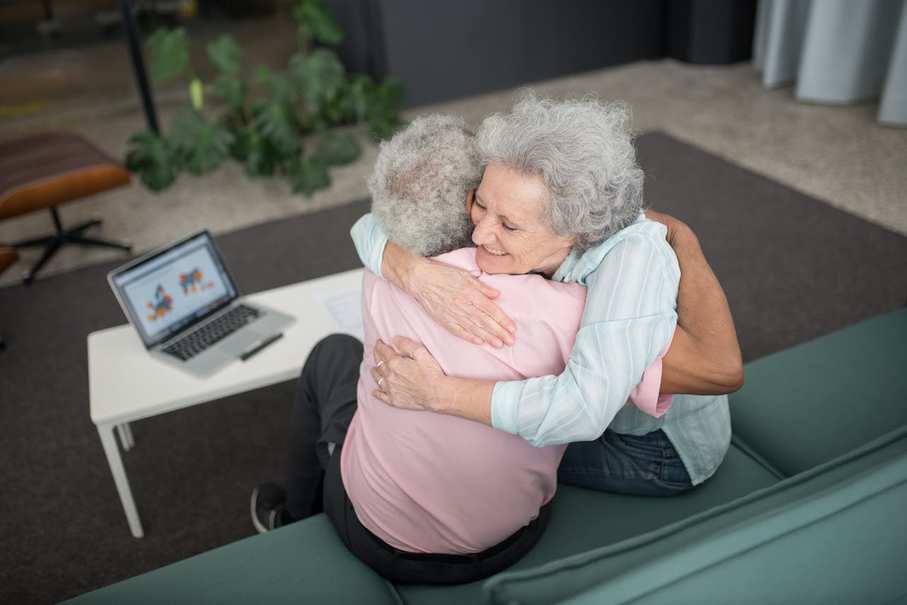 ours-journey A joyful moment of a senior couple embracing indoors, highlighting warmth and companionship.